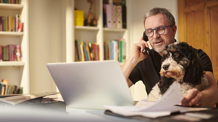Man on phone with dog