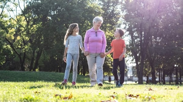 Grandmother walking with grandchildren