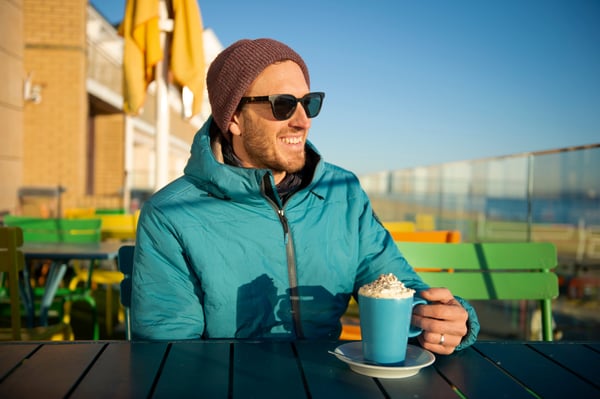 Man sitting outside with a hot coffee