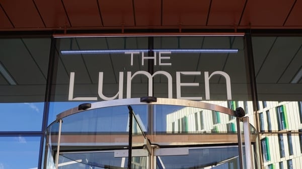 The Lumen logo over building entrance