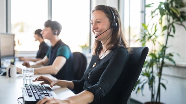 Smiling person in call centre