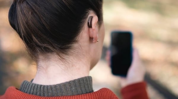 Person using text relay with a mobile phone