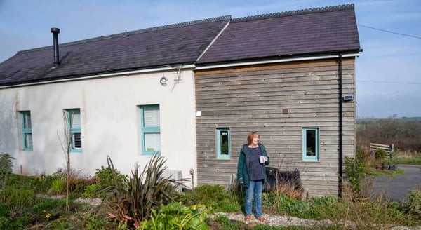 Woman standing outside house
