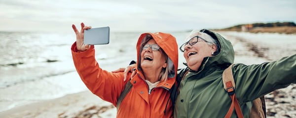 Two women laughing as they take a selfie
