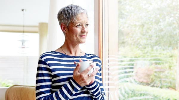 Older lady thoughtfully looking out of window