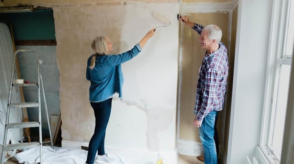 Couple painting wall