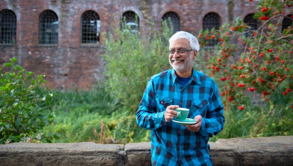 Man smiling with a cup of tea