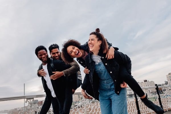 four young adults having fun outside