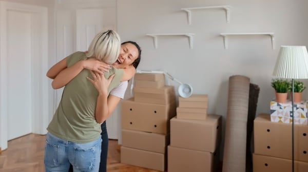 two woman celebrating in new home