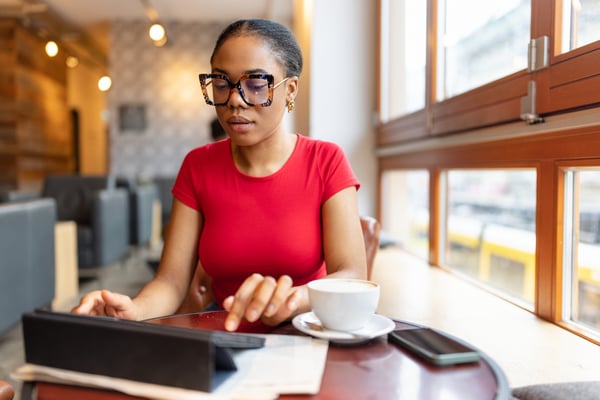 Woman wearing glasses reading ipad