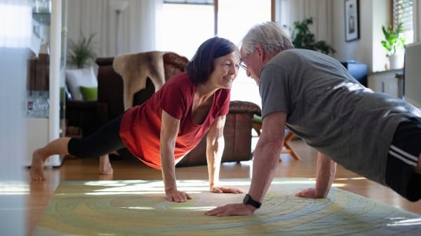 Mature couple exercising at home
