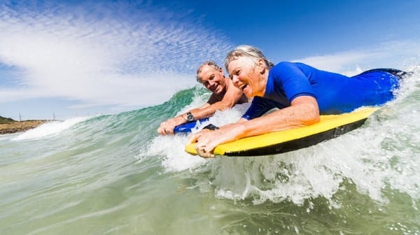 Senior couple bodyboarding