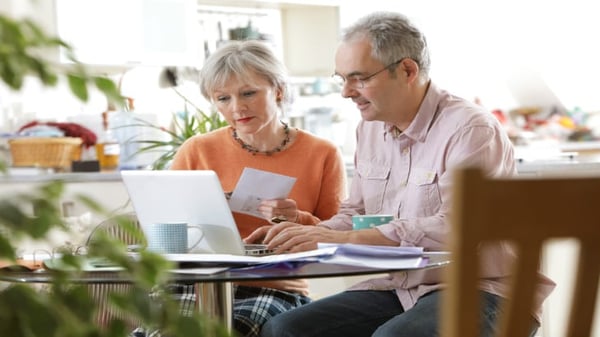 senior couple looking at laptop