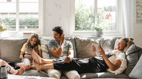 Family happily gathered on a sofa