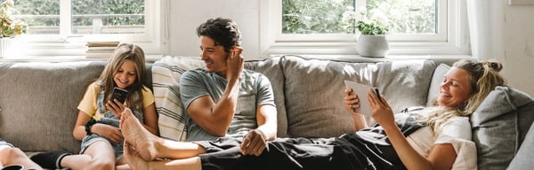 Family happily gathered on a sofa
