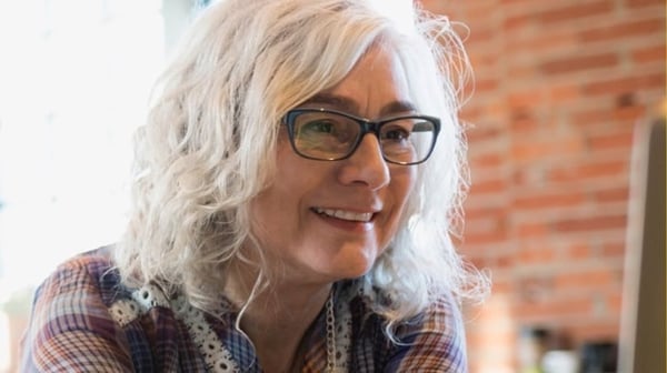 Older woman smiling at laptop