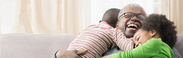 Grandfather on sofa with grandchildren