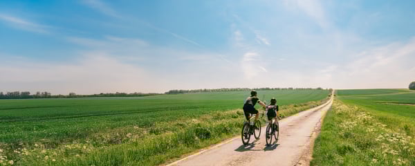 couple riding bike in countryside