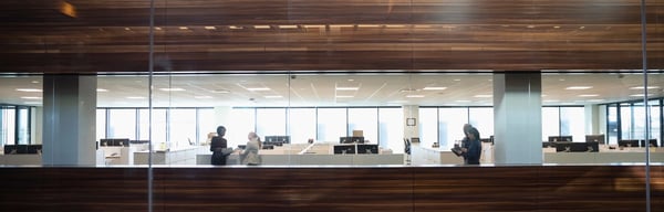 Colleagues chat within open offices