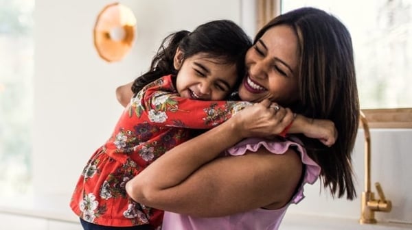 Woman hugging child