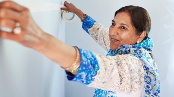 Woman putting up a whiteboard