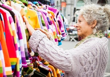 Woman looking at clothes on a market store