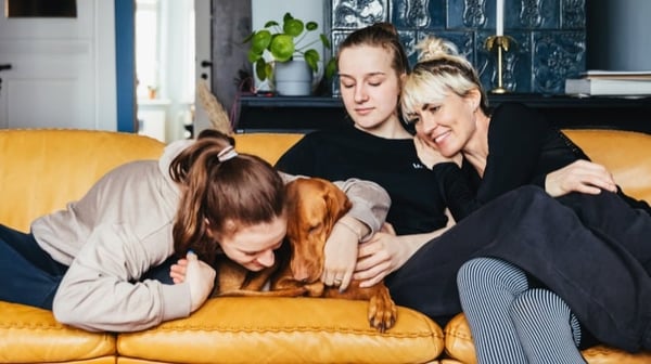 Family on sofa with dog
