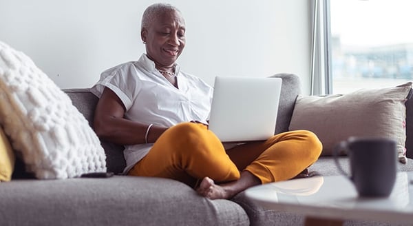 Woman on sofa with laptop