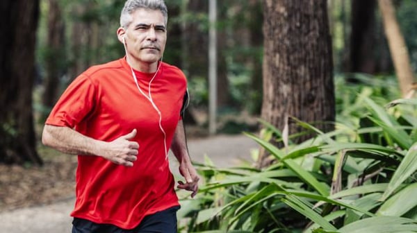 Man with headphones in on a jog.