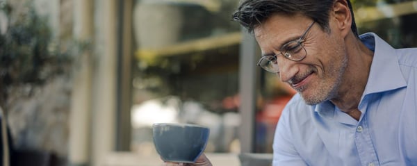 Smiling man with cup of tea