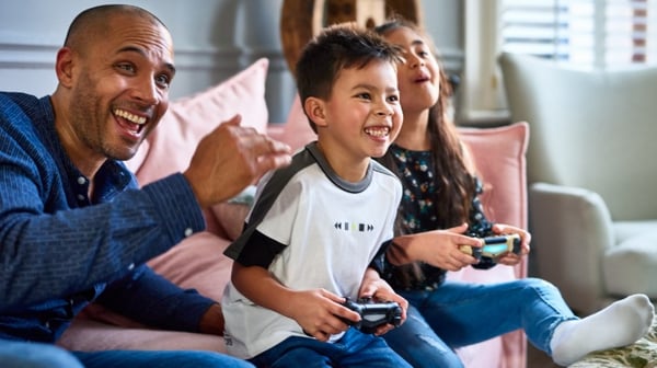 Family playing on computer in lounge