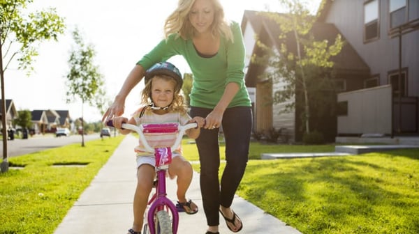 young-girl-learning-to-ride-a-bike