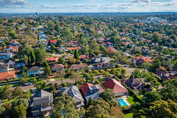 A birds eye view of a town, with trees and houses