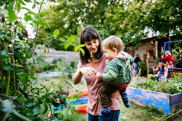 Woman smiling with baby in garden