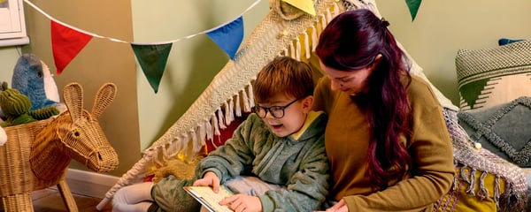 Mum and son reading a book at home