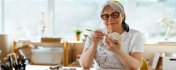 Lady painting a mug in studio