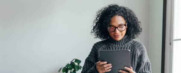 Woman smiling at ipad