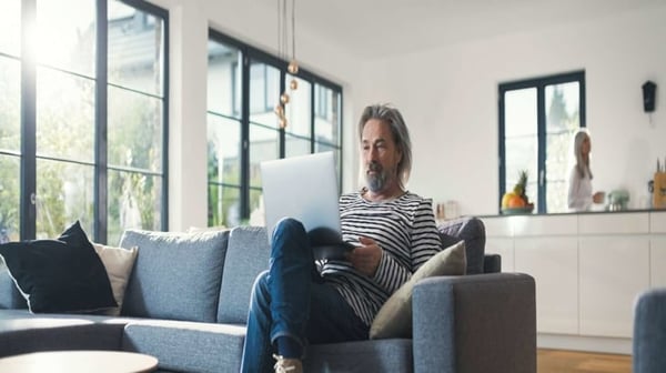 Man sitting on sofa with laptop