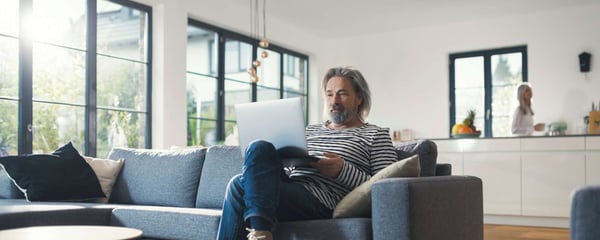 Man sitting on sofa with laptop