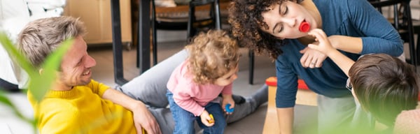 Happy family playing with kids at home