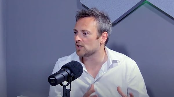 Man talking into a microphone in a studio