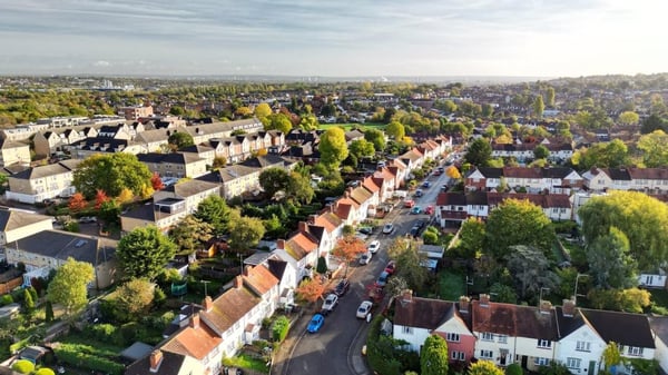 A birds eye view of a row of houses in a street with trees