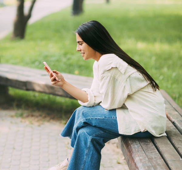 Woman smiling at her phone