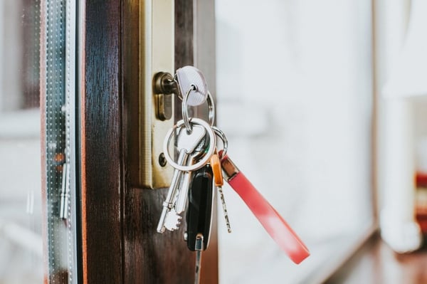 Close up image of a bunch of keys in a door