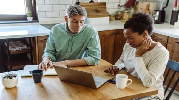 Couple in kitchen working through finances