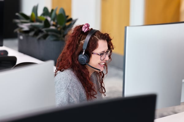 Contact centre call agent laughing while talking to a customer