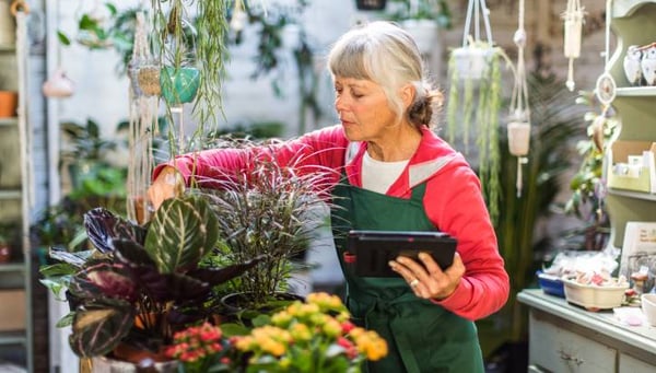 Senior woman working in garden shop