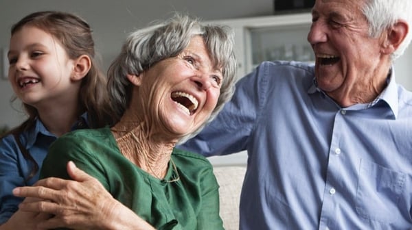 Smiling grandparents with grandchild