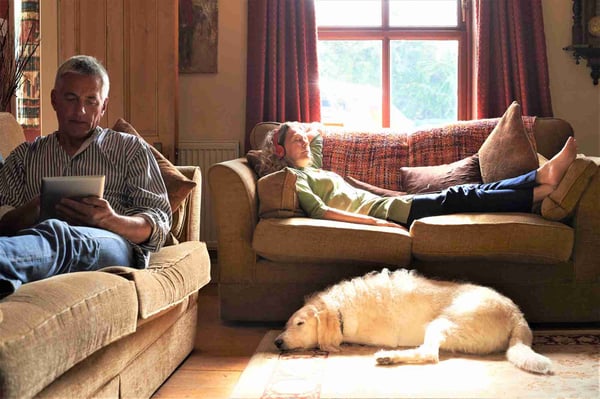 Couple lying on separate sofas
