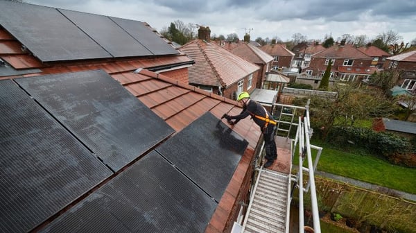 Man roofing a house